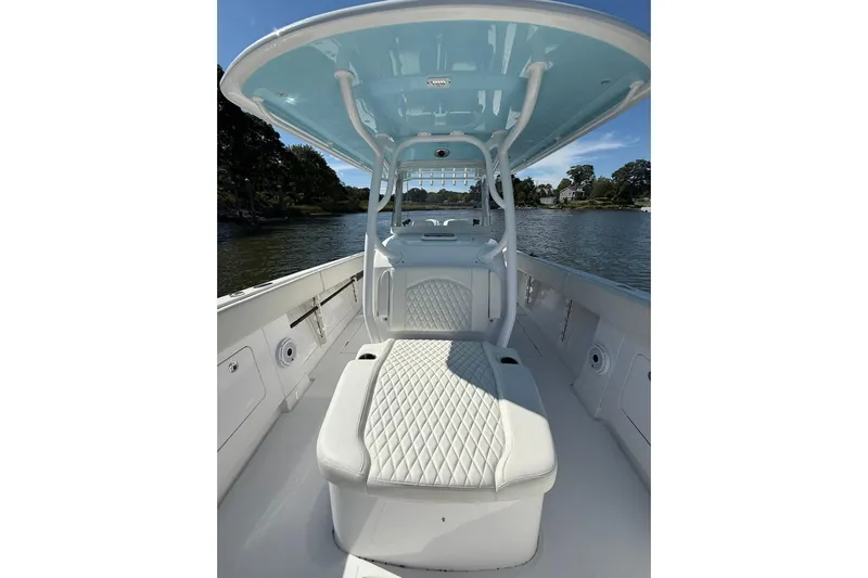  Yacht Photos Pics 2021 Jupiter 38 HFS boat interior with cushioned seating and overhead canopy on a sunny day.