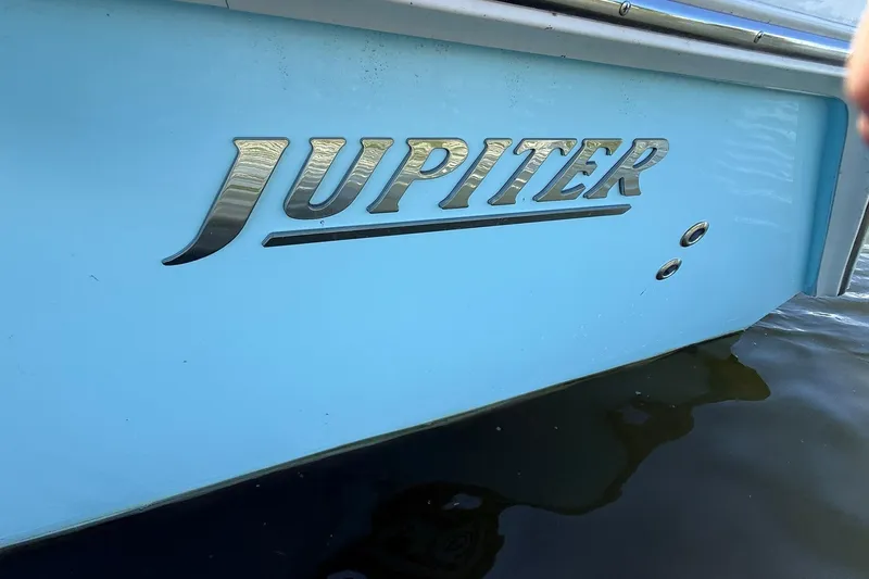  Yacht Photos Pics 2021 Jupiter 38 HFS boat with metallic logo on light blue hull.