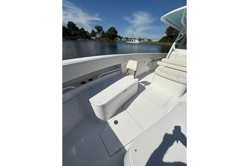  Yacht Photos Pics 2021 Jupiter 38 HFS boat interior with seating, on a calm waterway under blue skies.