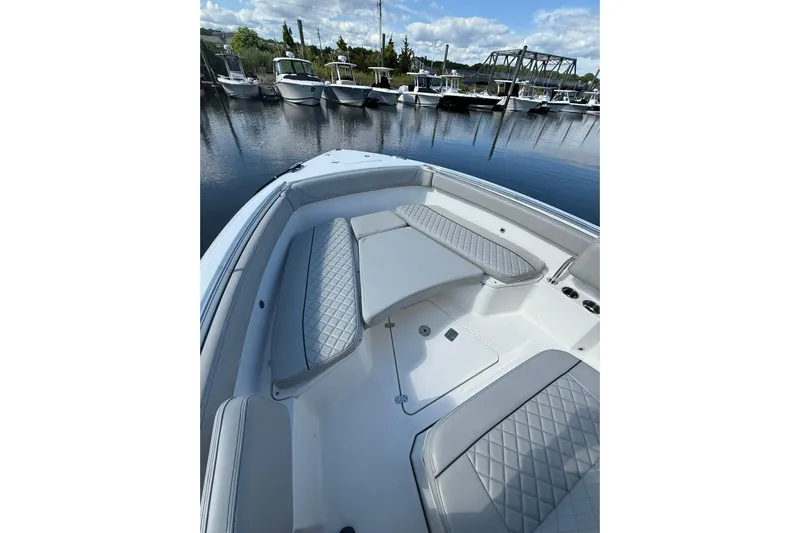  Yacht Photos Pics 2021 Jupiter 38 HFS boat interior with cushioned seating, docked at marina.