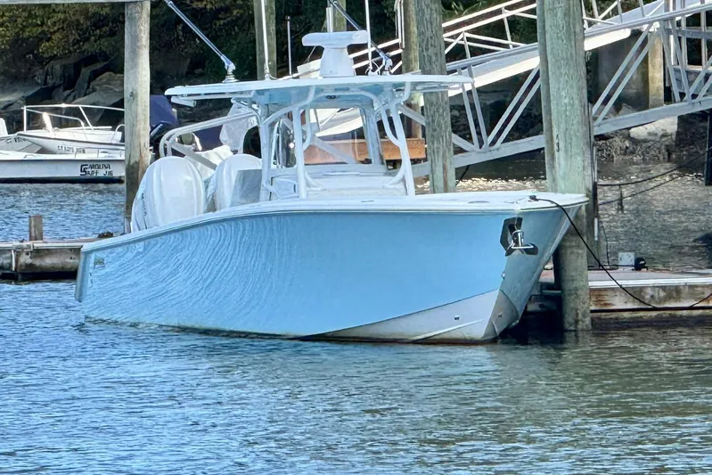  Yacht Photos Pics 2021 Jupiter 38 HFS boat docked in a marina, featuring a sleek blue hull.