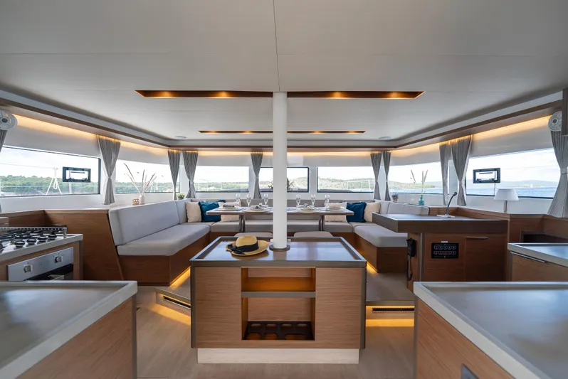Spellbound Yacht Photos Pics Luxurious interior of 2023 Lagoon 50 catamaran with modern furnishings and panoramic windows.