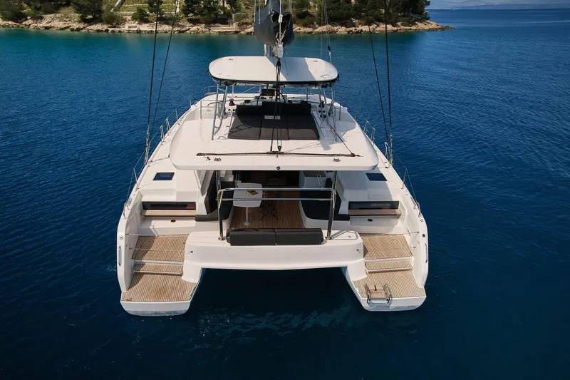 Spellbound Yacht Photos Pics 2023 Lagoon 50 catamaran on serene blue water, showcasing spacious deck and modern design.