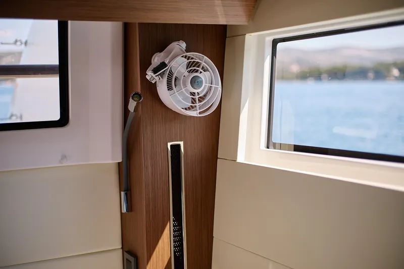 Spellbound Yacht Photos Pics Interior of 2023 Lagoon 50 yacht with fan and window view.
