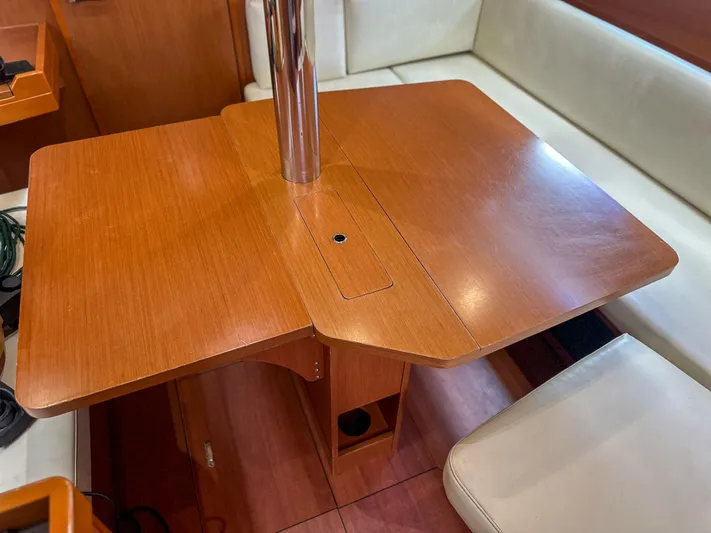 Sadalbari Yacht Photos Pics Interior of 2018 Beneteau Oceanis 41.1 yacht with wooden dining table and seating.