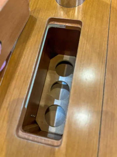 Sadalbari Yacht Photos Pics Wooden compartment on 2018 Beneteau Oceanis 41.1 yacht, featuring circular cutouts.