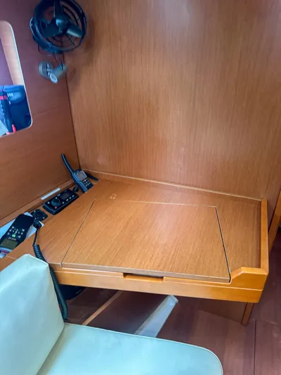 Sadalbari Yacht Photos Pics Navigation station in 2018 Beneteau Oceanis 41.1 yacht with wooden desk and communication equipment.