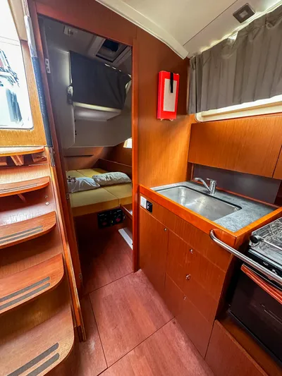 Sadalbari Yacht Photos Pics Interior of 2018 Beneteau Oceanis 41.1 yacht, featuring a compact kitchen and cozy cabin.
