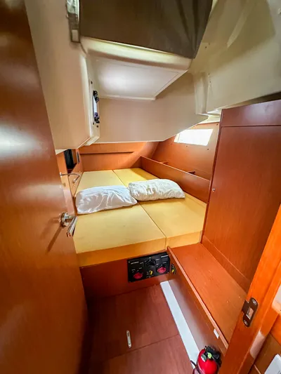 Sadalbari Yacht Photos Pics Cozy cabin interior of 2018 Beneteau Oceanis 41.1 sailboat with wooden finish and bedding.