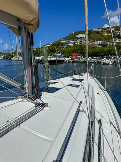 Sadalbari Yacht Photos Pics 2018 Beneteau Oceanis 41.1 sailboat docked in a scenic marina with hillside view.