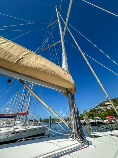 Sadalbari Yacht Photos Pics 2018 Beneteau Oceanis 41.1 sailboat mast and boom against clear blue sky.