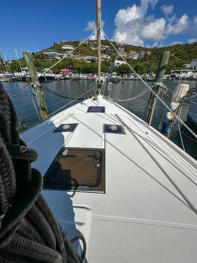 Sadalbari Yacht Photos Pics 2018 Beneteau Oceanis 41.1 sailboat docked in a marina, clear sky, and hillside view.