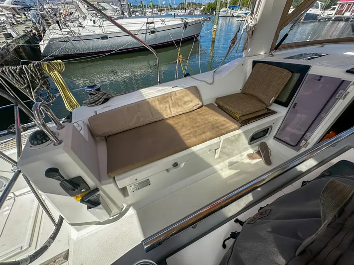 Sadalbari Yacht Photos Pics 2018 Beneteau Oceanis 41.1 yacht cockpit with cushioned seating and marina view.