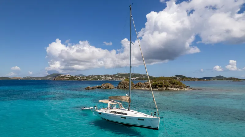 Sadalbari Yacht Photos Pics 2018 Beneteau Oceanis 41.1 sailboat anchored in clear turquoise waters under a blue sky.