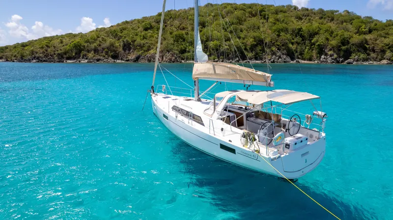Sadalbari Yacht Photos Pics 2018 Beneteau Oceanis 41.1 sailboat anchored in clear turquoise water near lush green island.