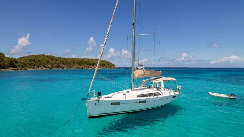 Sadalbari Yacht Photos Pics 2018 Beneteau Oceanis 41.1 sailboat anchored in clear turquoise waters, scenic island backdrop.