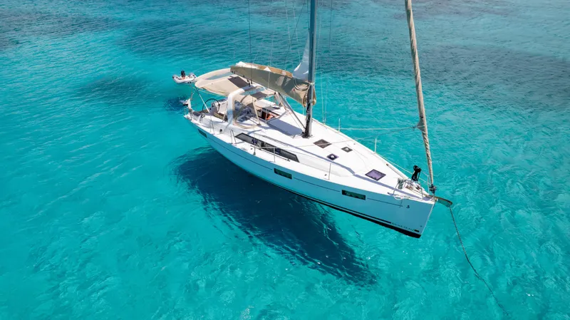 Sadalbari Yacht Photos Pics 2018 Beneteau Oceanis 41.1 sailboat anchored in clear turquoise water.