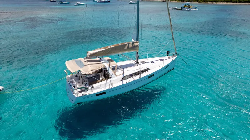 Sadalbari Yacht Photos Pics 2018 Beneteau Oceanis 41.1 sailboat anchored in clear turquoise waters.