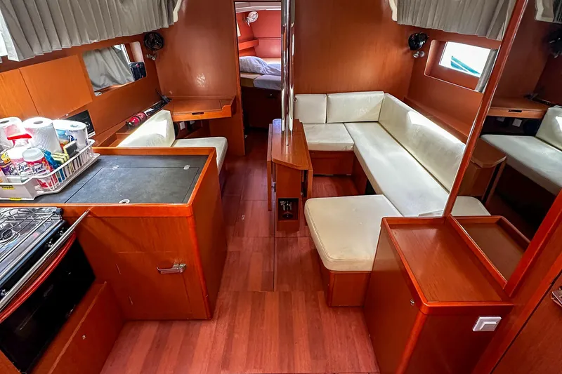Sadalbari Yacht Photos Pics Interior of 2018 Beneteau Oceanis 41.1 yacht with kitchen and seating area.
