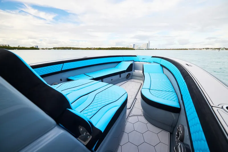  Yacht Photos Pics 2024 Midnight Express 37' Open boat with luxurious blue seating on a calm water backdrop.