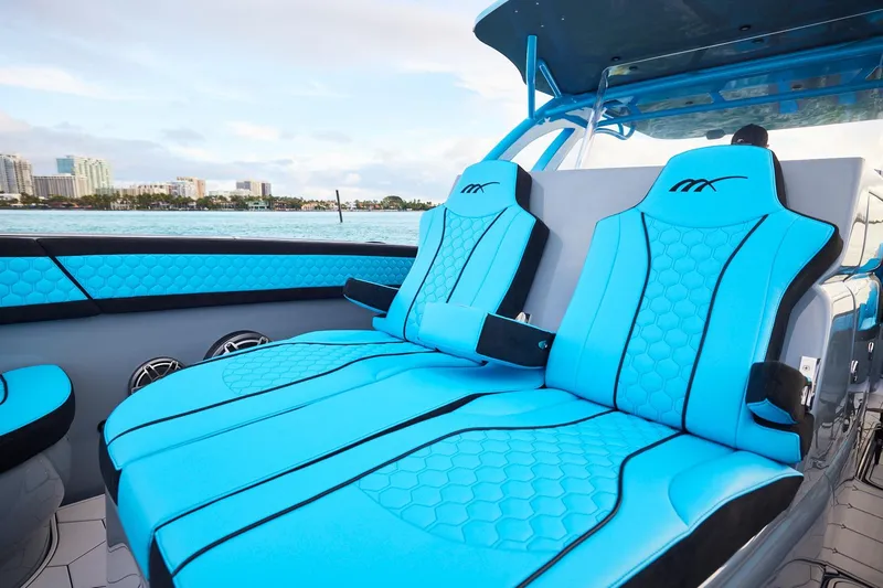  Yacht Photos Pics 2024 Midnight Express 37' Open boat with luxurious blue seating and waterfront view.