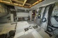 Interior of a Custom HARD TOP 78 yacht under construction, showcasing wiring and unfinished components.