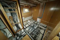 Interior of a 2025 Custom HARD TOP 78 yacht under construction, showing wiring and unfinished woodwork.