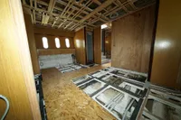 Under-construction interior of Custom HARD TOP 78 yacht, showcasing unfinished woodwork and exposed framework.