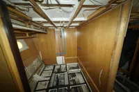Under-construction interior of Custom HARD TOP 78 yacht, featuring exposed wiring and wooden panels.