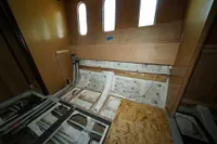 Under-construction interior of Custom HARD TOP 78 yacht, showcasing unfinished wood and metal framework.