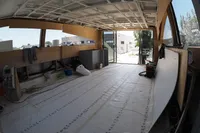 Under-construction interior of Custom HARD TOP 78 yacht, 2025 model, with open space and materials.