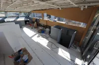Interior of a 2025 Custom HARD TOP 78 yacht under construction, featuring tools and materials.