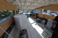 Interior of a 2025 Custom HARD TOP 78 yacht under construction, featuring tools and materials.