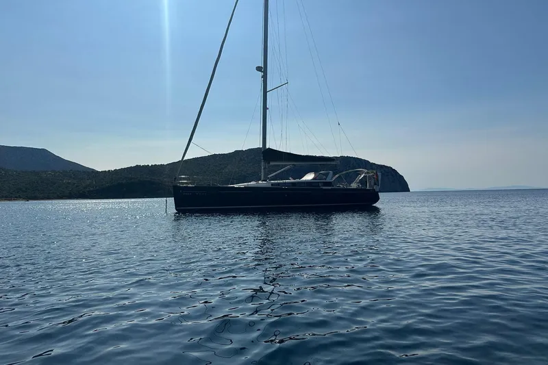 Boxter Yacht Photos Pics 2013 Beneteau Sense 50 sailboat on calm sea with scenic coastal backdrop.