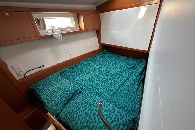 Boxter Yacht Photos Pics Cozy cabin interior of 2013 Beneteau Sense 50 yacht with teal bedding.