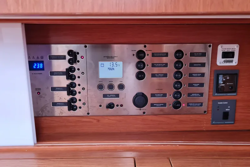Boxter Yacht Photos Pics Control panel of a 2013 Beneteau Sense 50 yacht, featuring various switches and displays.