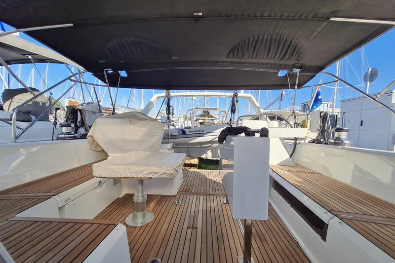 Boxter Yacht Photos Pics 2013 Beneteau Sense 50 yacht interior with wooden deck and covered seating area.