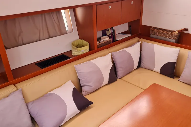 Boxter Yacht Photos Pics Interior of 2013 Beneteau Sense 50 yacht with cozy seating and decorative pillows.