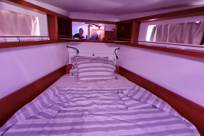 Boxter Yacht Photos Pics Cozy cabin interior of 2013 Beneteau Sense 50 yacht with striped bedding.