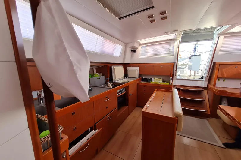 Boxter Yacht Photos Pics Interior of 2013 Beneteau Sense 50 yacht, featuring a modern kitchen and dining area.