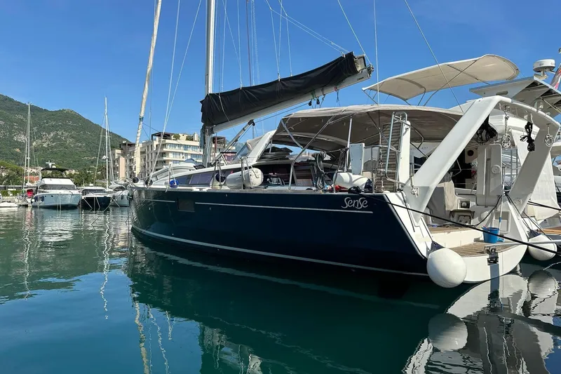 Boxter Yacht Photos Pics 2013 Beneteau Sense 50 yacht docked in a marina, with scenic mountain backdrop.