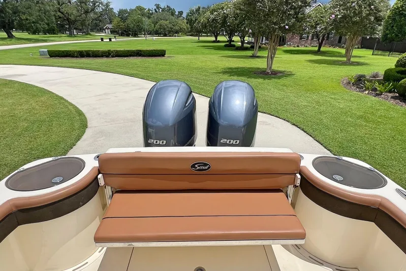  Yacht Photos Pics 2014 Scout 275 LXF boat with twin 200 engines, parked on a driveway.