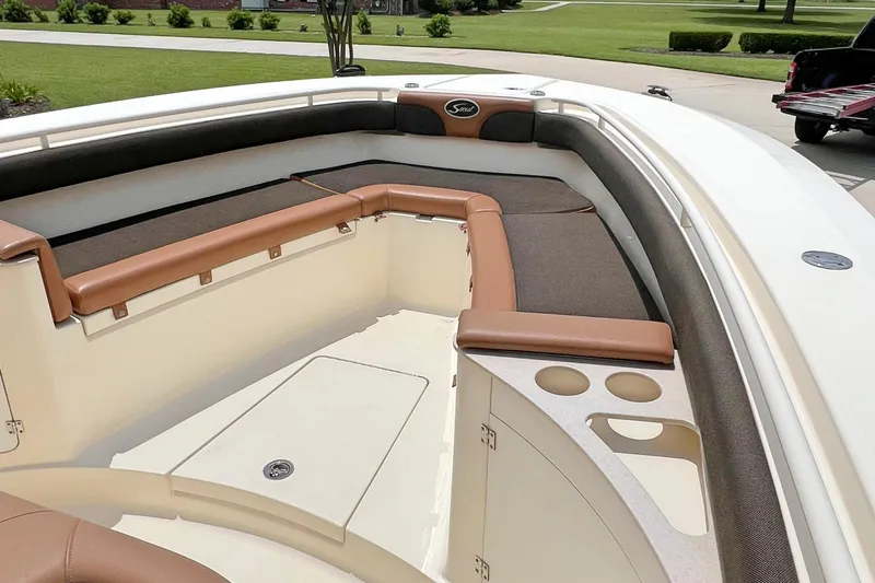  Yacht Photos Pics 2014 Scout 275 LXF boat interior with cushioned seating and cup holders.