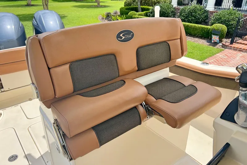  Yacht Photos Pics 2014 Scout 275 LXF boat seat with tan and black upholstery, outdoor setting.