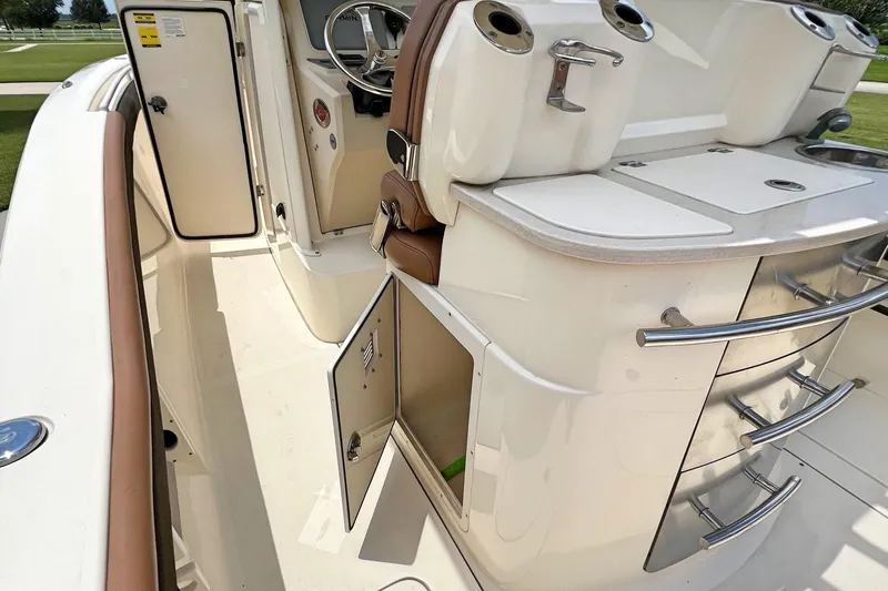  Yacht Photos Pics 2014 Scout 275 LXF boat interior with open storage compartments and sleek design.