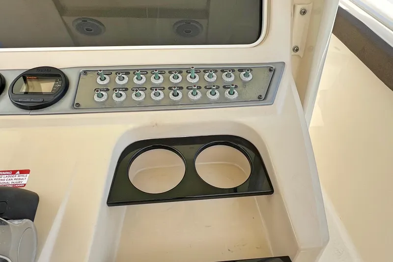 Yacht Photos Pics Control panel of 2014 Scout 275 LXF boat with cup holders and switches.