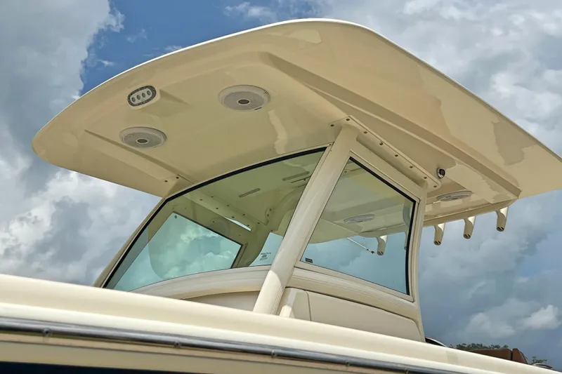  Yacht Photos Pics 2014 Scout 275 LXF boat with sleek hardtop against cloudy sky.