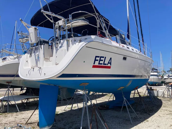 Fela Yacht Photos Pics 2009 Hunter 49 Aft Cockpit sailboat on stands, named "FELA," with blue hull and canopy.