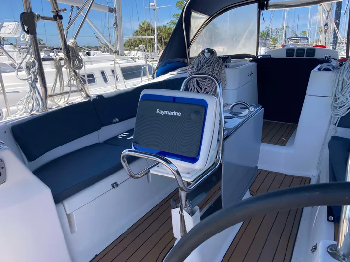 Fela Yacht Photos Pics 2009 Hunter 49 Aft Cockpit sailboat interior with Raymarine equipment and seating.