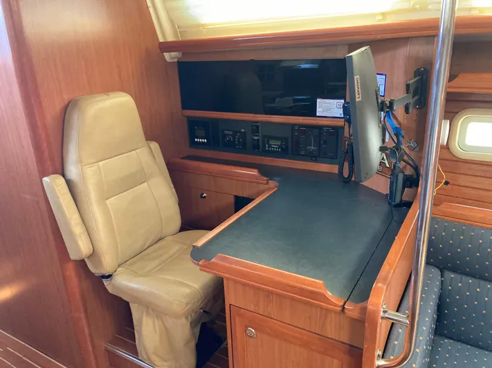 Fela Yacht Photos Pics 2009 Hunter 49 Aft Cockpit interior with navigation station and beige chair.